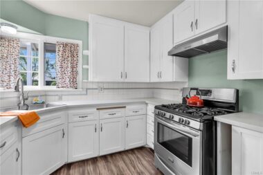 Remodeled kitchen with Stylestone counter top, laminate flooring, newer gas stove and refrigerator included.