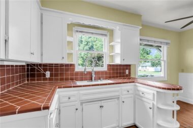 Brand new items are the faucet, light fixture, and ceiling fan, with newer disposal, refrigrator, stove, microwave, dishwasher, and laminate flooring.