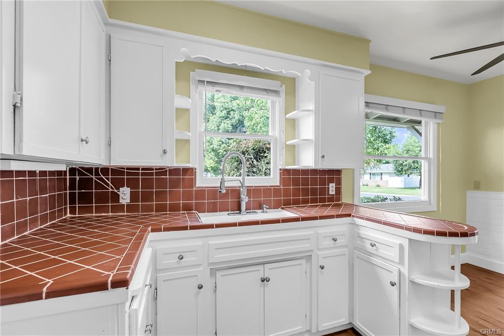 Brand new items are the faucet, light fixture, and ceiling fan, with newer disposal, refrigrator, stove, microwave, dishwasher, and laminate flooring.