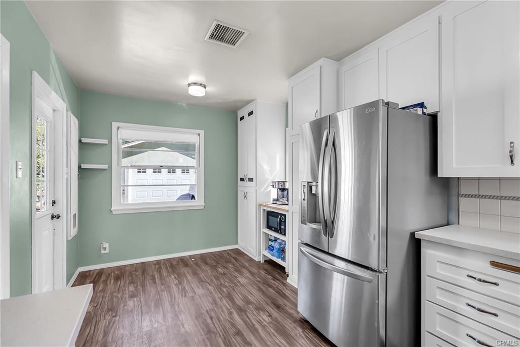 Alternate view of remodeled kitchen with breakfast nook and coffee station.
