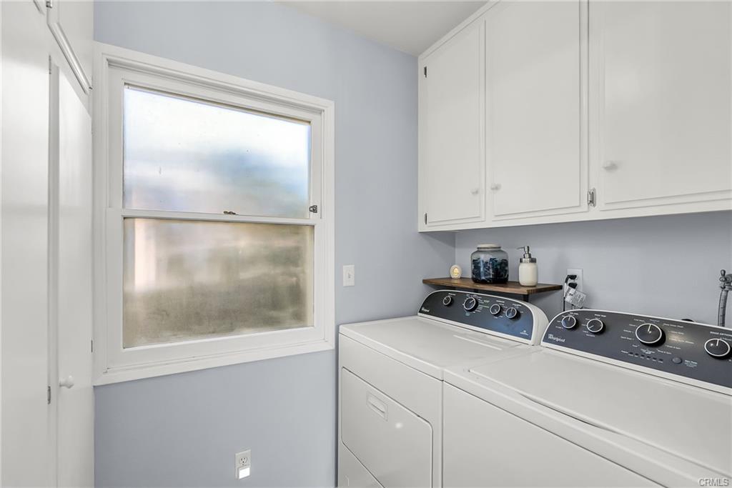 Laundry room with lots off cabinetry and storage. Washer/dryer included.