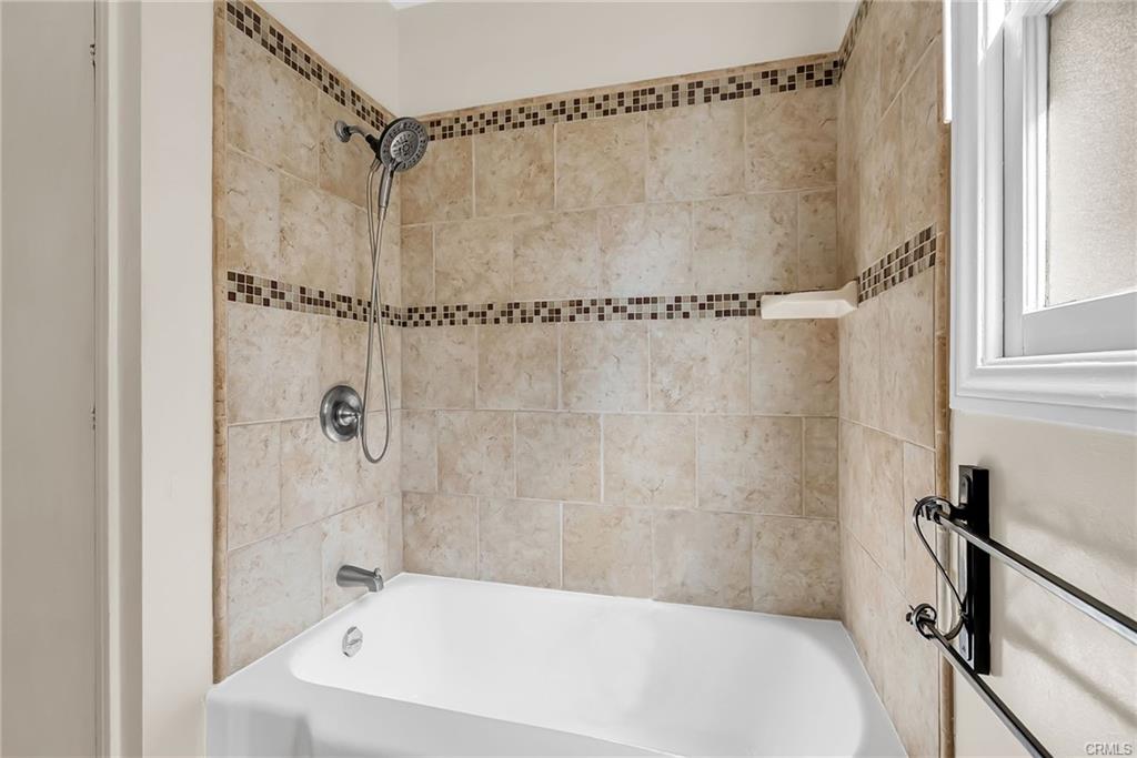 Remodeled shower/tub space in hallway bathroom.