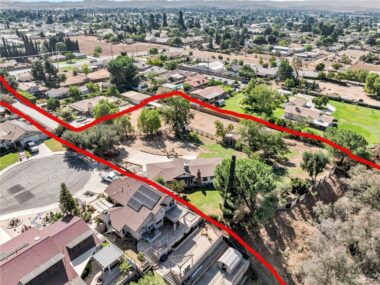 Douglas Road, off of Avenue H, belongs to this property. The subject property also includes the hillside that drops below the property, which abuts Avenue G. The hillside is accessed through a gate at the far corner of the yard past the chicken coop. The full hillside can be seen in the next photo.