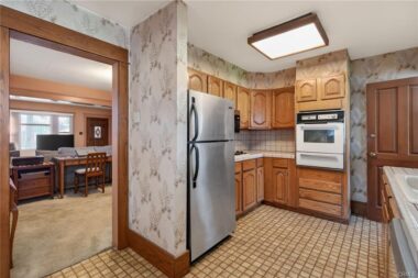 View from breakfast nook into the kitchen and the formal dining room.