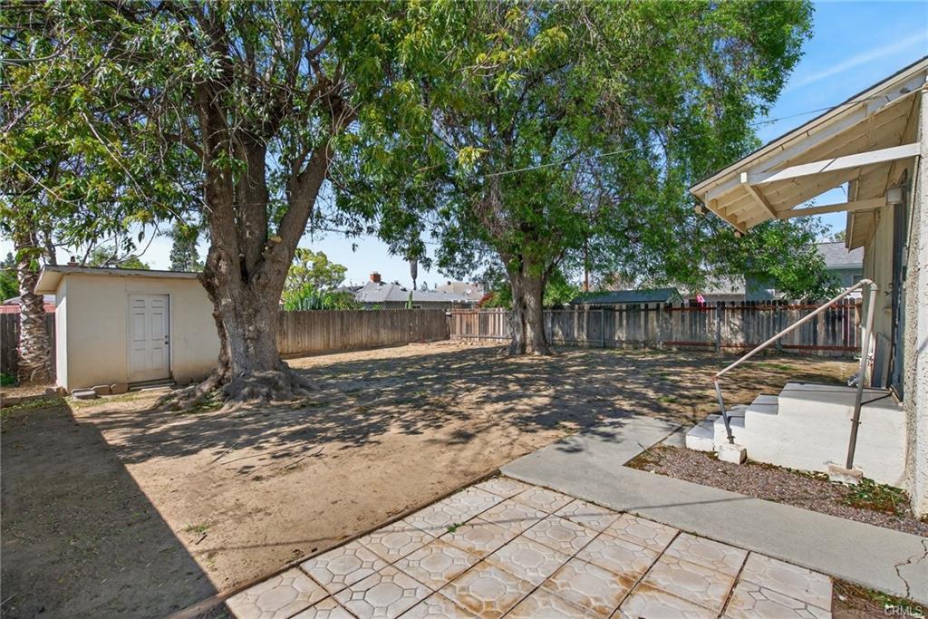 View of backyard from area behind the garage, which could be used for patio table and chairs, or a dog run.