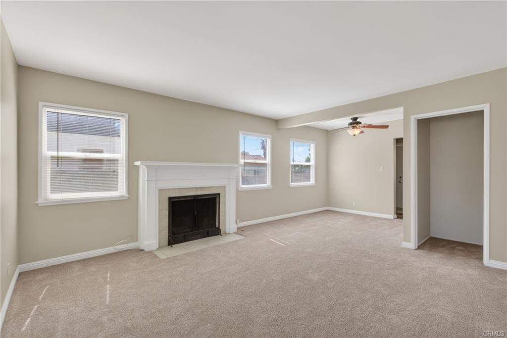 View of living room to the dining area with ceiling fan just off the kitchen.