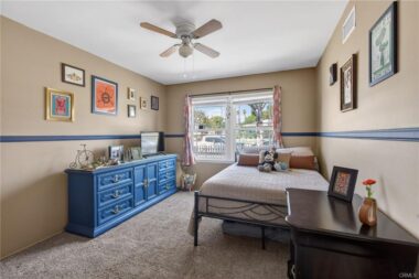Bedroom #2 with carpeting and ceiling fan.