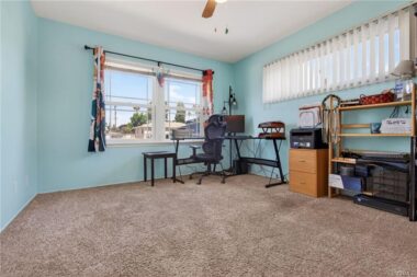 Bedroom #3 with carpeting and ceiling fan.