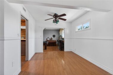 Formal Dining Room with kitchen to the left and step-down bonus room for pool table and bar area straight ahead.