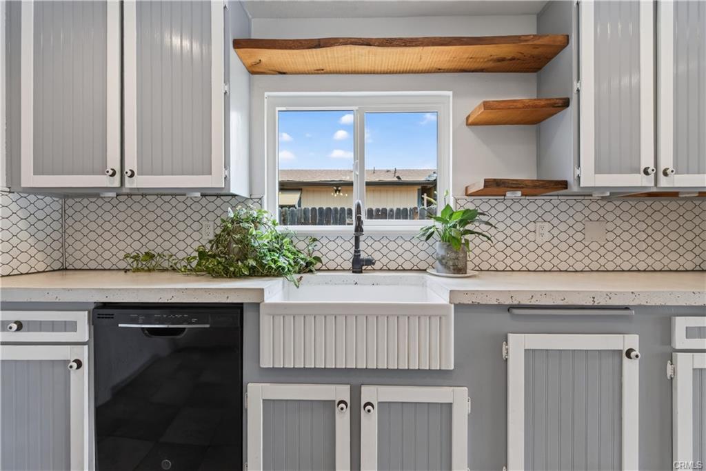 Kitchen with cement counter tops, farm kitchen, and dishwasher.