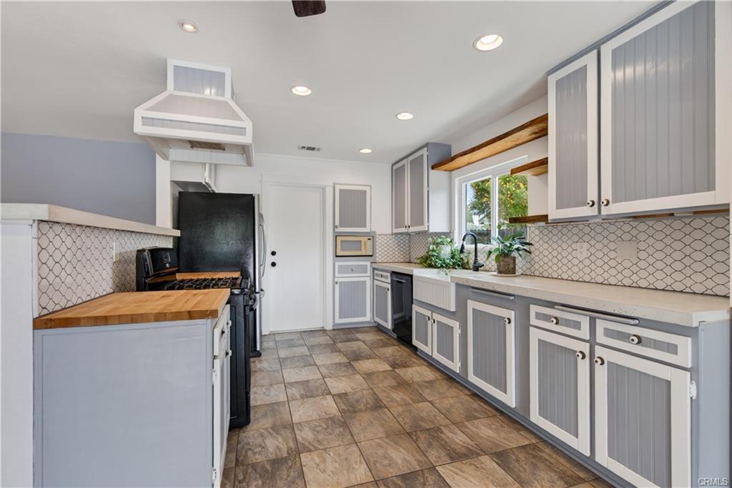 Kitchen with gas stove, refrigerator, microwave, and dishwasher.