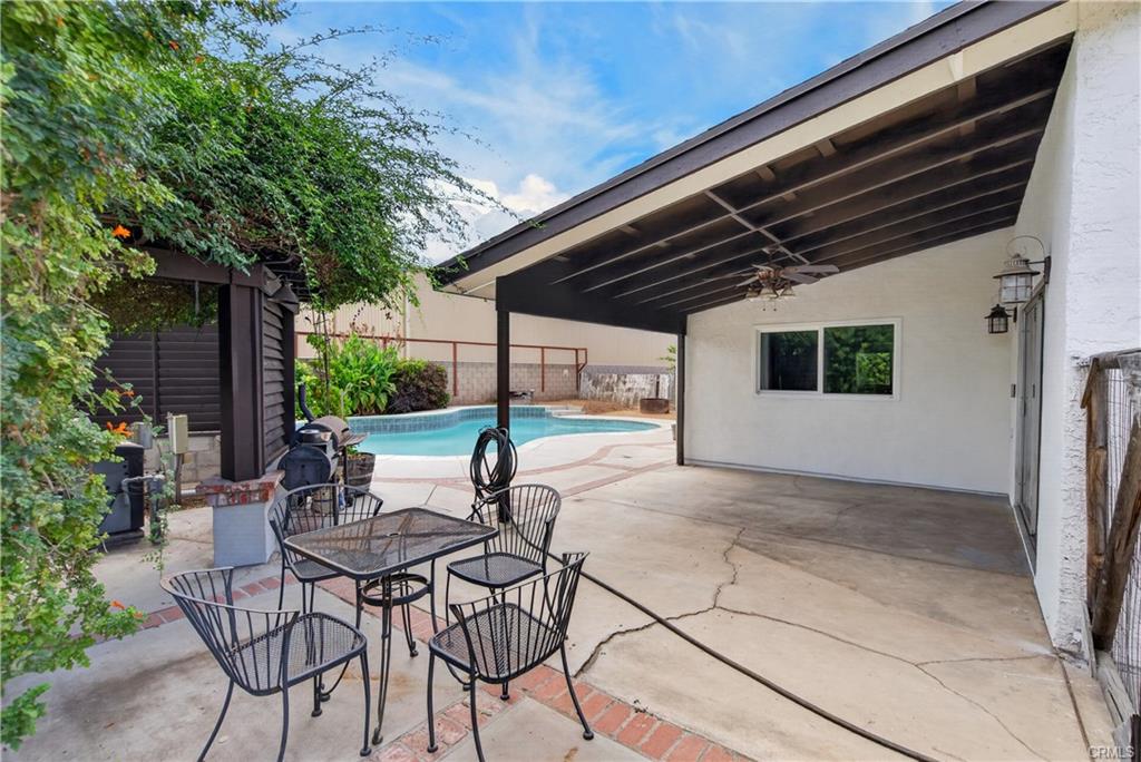 Another view of covered back patio and protected pool equipment to the left -- gate to the right leads to the side yard that could be a dog run, or additional storage.