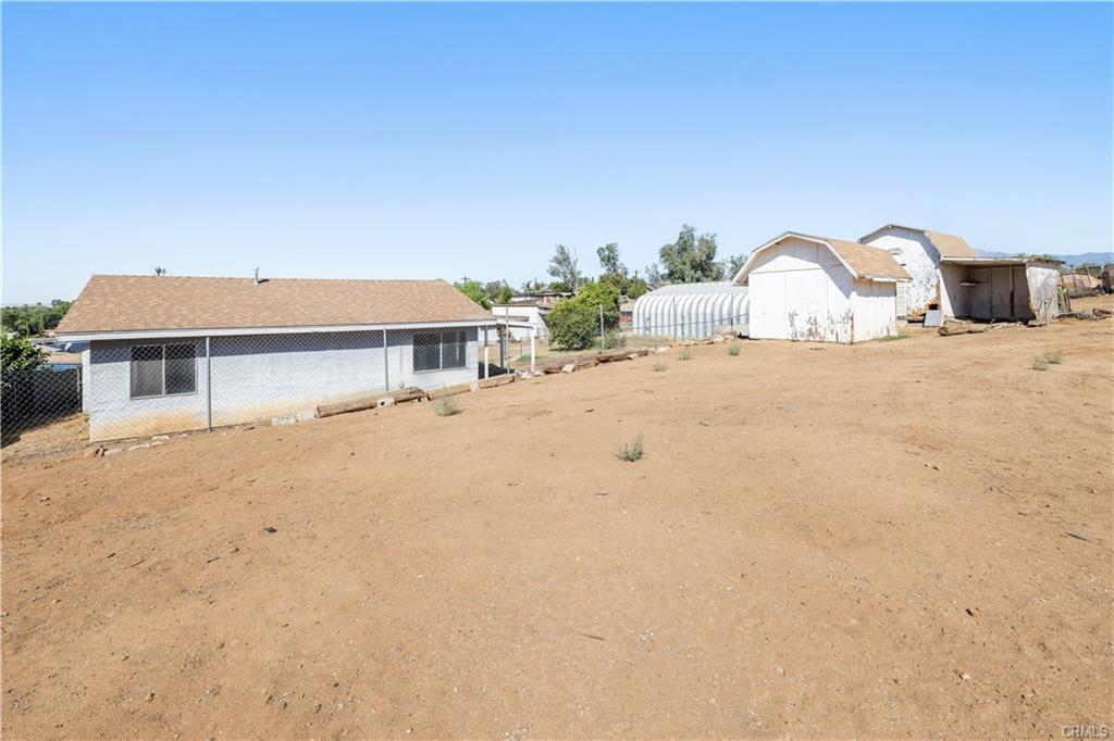 PERMITTED ADU: View from the back of the property, along with two additional sheds, and the workshop as well.