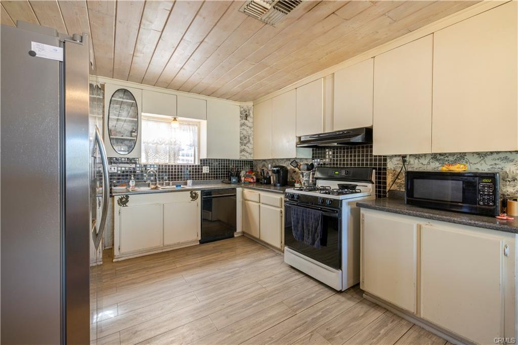 MAIN HOUSE: Ample sized kitchen with space for a preparation island. Appliances stay.