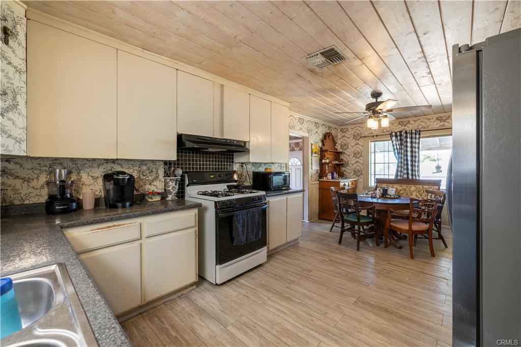 MAIN HOUSE: spacious kitchen with view toward the eating area with room for 2 hutches if needed.