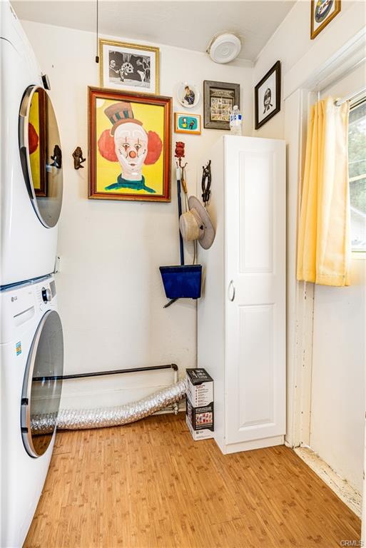 Separate indoor laundry room with stackable washer/dryer.