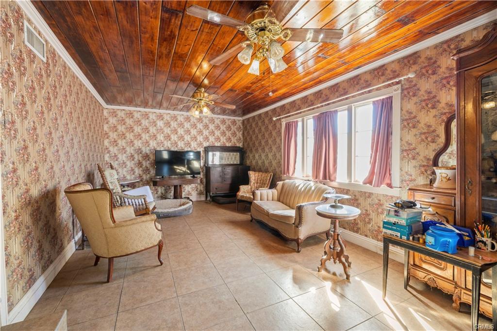 MAIN HOUSE: View of living room with wood ceiling as you enter the front door.