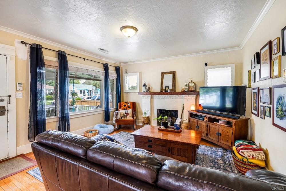 Living room with 8 1/2 ft tall ceilings and wood-burning fireplace.