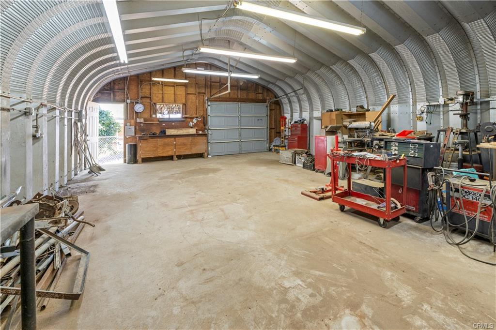 WORKSHOP INTERIOR -- photo taken from back of the building with a view of the man door and the garage door access.